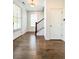 Inviting foyer with gleaming hardwood floors and a staircase with iron railing at 1166 Farmstead Rd, Suwanee, GA 30024