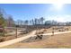 Community walking paths with new construction homes in the background with mature trees at 1166 Farmstead Rd, Suwanee, GA 30024