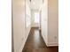 Hallway featuring hardwood floors, white walls, and bright natural light at 1166 Farmstead Rd, Suwanee, GA 30024
