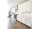 Bright kitchen featuring stainless appliances, white cabinets, subway tile backsplash and hardwood floors at 1166 Farmstead Rd, Suwanee, GA 30024