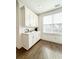 Breakfast nook area with white cabinets, stainless coffee maker, and a bright window with a view at 1166 Farmstead Rd, Suwanee, GA 30024
