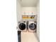 Laundry room with front loading machines, folding counter and lots of storage space at 1166 Farmstead Rd, Suwanee, GA 30024