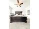 Main bedroom featuring neutral carpet, fan, and large bed at 1166 Farmstead Rd, Suwanee, GA 30024