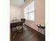 Office space with dark hardwood floors, a modern desk, and a large window at 1166 Farmstead Rd, Suwanee, GA 30024