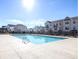 A community pool surrounded by new construction townhomes on a sunny day at 1166 Farmstead Rd, Suwanee, GA 30024