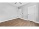 This bedroom features hardwood floors, neutral paint, a ceiling fan, and has closet access at 1716 Browning Sw St, Atlanta, GA 30314