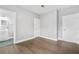 Bright bedroom features hardwood floors, neutral paint, and natural light with ensuite bath access at 1716 Browning Sw St, Atlanta, GA 30314