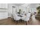Open-concept dining area featuring a modern table with seating, hardwood floors, and easy access to the living area at 1716 Browning Sw St, Atlanta, GA 30314