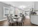 Dining room with modern table and seating, hardwood floors, and large windows for abundant natural light at 1716 Browning Sw St, Atlanta, GA 30314