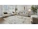 Spacious living room featuring modern decor, a neutral color palette, stylish furniture, and plenty of natural light at 1716 Browning Sw St, Atlanta, GA 30314