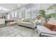 Living room with large windows, neutral colors, modern furnishings, and stylish rug at 1716 Browning Sw St, Atlanta, GA 30314