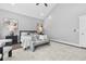 Spacious main bedroom with a neutral color scheme, ceiling fan, windows, and modern décor at 1716 Browning Sw St, Atlanta, GA 30314