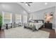 Bright main bedroom with ceiling fan, windows, neutral color palette and modern decor at 1716 Browning Sw St, Atlanta, GA 30314
