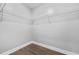 A walk-in closet with white wire shelving and wood-look flooring at 1716 Browning Sw St, Atlanta, GA 30314