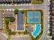 Aerial view of community pool and tennis courts, parking, playground, and surrounding residential streets at 2436 Sardis Chase Ct, Buford, GA 30519