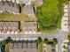 Aerial view of neighborhood street, showing many homes with manicured lawns and surrounding green spaces at 2436 Sardis Chase Ct, Buford, GA 30519