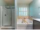 Bright bathroom features a walk-in shower and a soaking tub with tile surround at 2436 Sardis Chase Ct, Buford, GA 30519