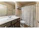 Well-lit bathroom with modern vanity, toilet, and shower with patterned curtain at 2436 Sardis Chase Ct, Buford, GA 30519