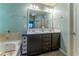 Bright bathroom featuring a double vanity and a soaking tub at 2436 Sardis Chase Ct, Buford, GA 30519