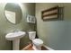 Cozy half bathroom features a pedestal sink and wooden accents, perfect for guests at 2436 Sardis Chase Ct, Buford, GA 30519