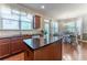 Open kitchen area with hardwood floors, an island with granite countertops, and adjacent dining area at 2436 Sardis Chase Ct, Buford, GA 30519