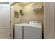 Convenient laundry room featuring a washer, dryer, and overhead storage shelf at 2436 Sardis Chase Ct, Buford, GA 30519