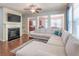 Comfortable living room featuring a fireplace, built-in shelving, and ample seating at 2436 Sardis Chase Ct, Buford, GA 30519
