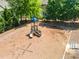 Playground area featuring a slide and climbing structure, surrounded by trees and a wood chip safety surface at 2436 Sardis Chase Ct, Buford, GA 30519