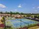 Overhead shot of the community tennis courts and clubhouse, showing the well-maintained facilities under a blue sky at 2436 Sardis Chase Ct, Buford, GA 30519