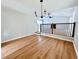 Dining room featuring hardwood floors, chandelier, and view to stairs and living room at 440 Sheppard Xing Ct, Stone Mountain, GA 30083