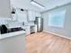 Bright kitchen with stainless steel appliances, white cabinets, hardwood floors, and polka dot backsplash at 440 Sheppard Xing Ct, Stone Mountain, GA 30083