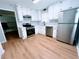 Well-lit kitchen boasts updated cabinets, stainless steel appliances, and stylish backsplash at 440 Sheppard Xing Ct, Stone Mountain, GA 30083