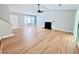 Sunlit living room with a fireplace, hardwood floors, and bay window at 440 Sheppard Xing Ct, Stone Mountain, GA 30083