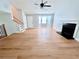 Bright living room featuring hardwood floors, a fireplace, and stairs at 440 Sheppard Xing Ct, Stone Mountain, GA 30083