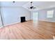 Open living room with vaulted ceilings, fan, fireplace, hardwood floors, and natural light at 440 Sheppard Xing Ct, Stone Mountain, GA 30083