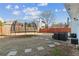 A spacious backyard featuring a trampoline, a patio area, and a well-maintained fence at 1240 Birchwood Ln, Roswell, GA 30076
