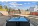 View of the backyard featuring an outdoor dining set, a trampoline, and a secure fence at 1240 Birchwood Ln, Roswell, GA 30076