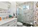 Modern bathroom features marble walls, glass-enclosed shower, and updated vanity at 1240 Birchwood Ln, Roswell, GA 30076