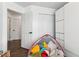 Bright bedroom features wood floors, built-in storage, and views of the hallway at 1240 Birchwood Ln, Roswell, GA 30076