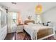 Bright bedroom featuring a queen-size bed, walk in closet, and modern decor at 1240 Birchwood Ln, Roswell, GA 30076