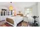 Bright bedroom featuring a queen-size bed, walk in closet, and modern decor at 1240 Birchwood Ln, Roswell, GA 30076
