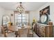Dining room with a round wooden table, chandelier, and modern decor at 1240 Birchwood Ln, Roswell, GA 30076