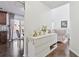 Hallway featuring hardwood floors and stylish decor leading to a bright and inviting living room and kitchen at 1240 Birchwood Ln, Roswell, GA 30076
