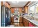 Bright kitchen featuring stainless steel appliances, wood cabinets, and granite countertops at 1240 Birchwood Ln, Roswell, GA 30076