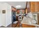 Cozy kitchen with stainless steel appliances, dark wood cabinets, and wood floors at 1240 Birchwood Ln, Roswell, GA 30076