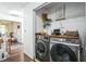 Functional laundry area features a front-load washer/dryer and built-in shelving at 1240 Birchwood Ln, Roswell, GA 30076