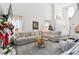 Open concept living room with cathedral ceilings, large windows, and modern furnishings perfect for entertaining at 1240 Birchwood Ln, Roswell, GA 30076