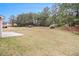 Spacious backyard featuring a well-maintained lawn and tree line in the background at 2036 Broadmoor Way, Fairburn, GA 30213