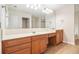 Bathroom featuring a long vanity with light wood cabinets, tile floors and a large mirror at 2036 Broadmoor Way, Fairburn, GA 30213