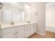 Bathroom with double vanity, white cabinets, tile floors and a separate tub at 2036 Broadmoor Way, Fairburn, GA 30213